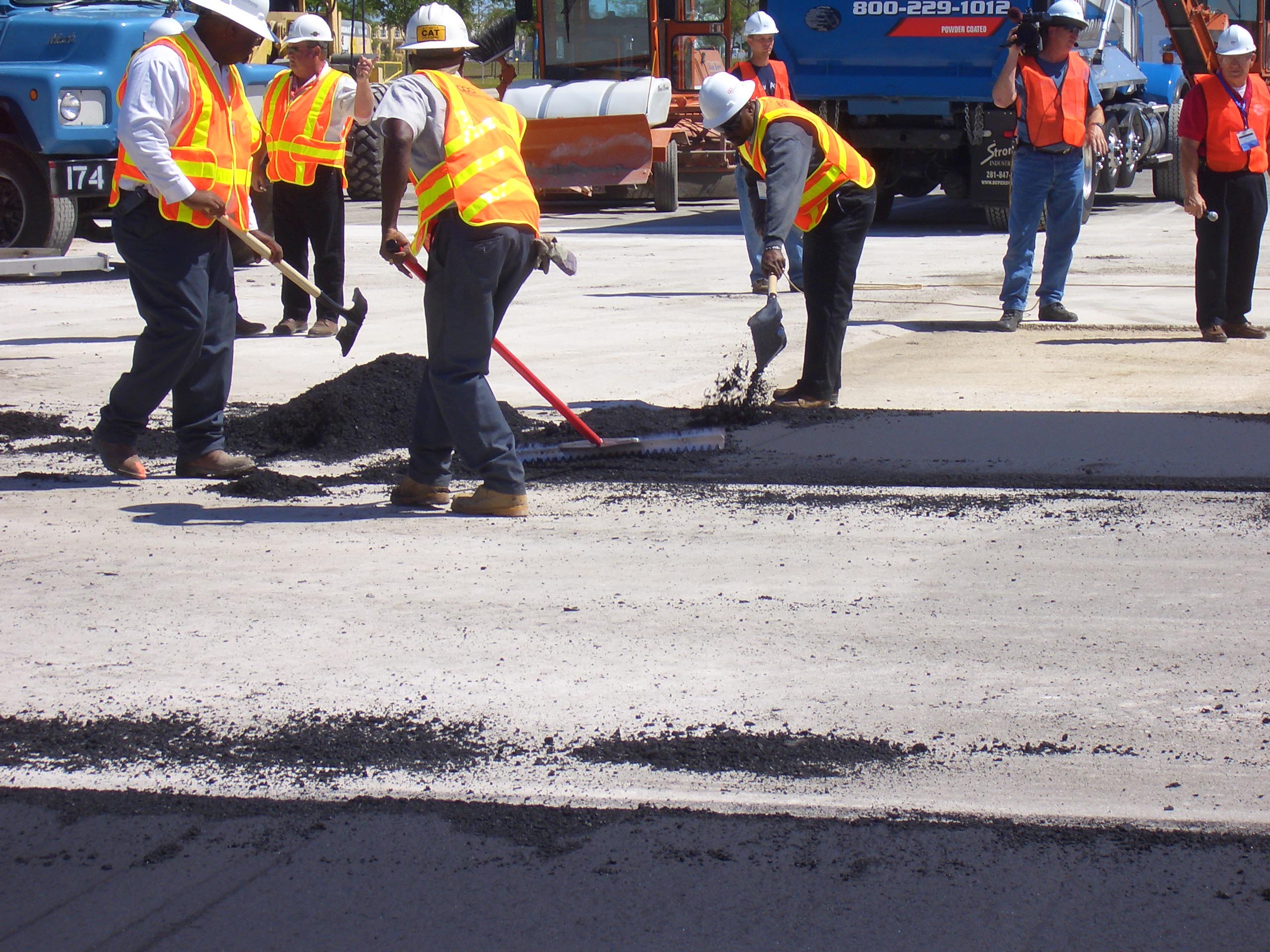 spreading material during asphalt application